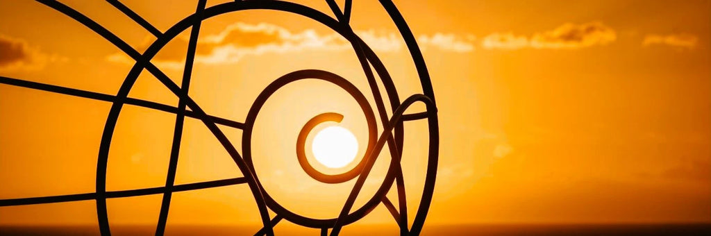 Sun sits perfectly in the center of a spiral statue