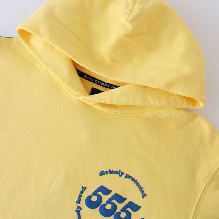 Yellow hoodie with blue text 555 on a white background
