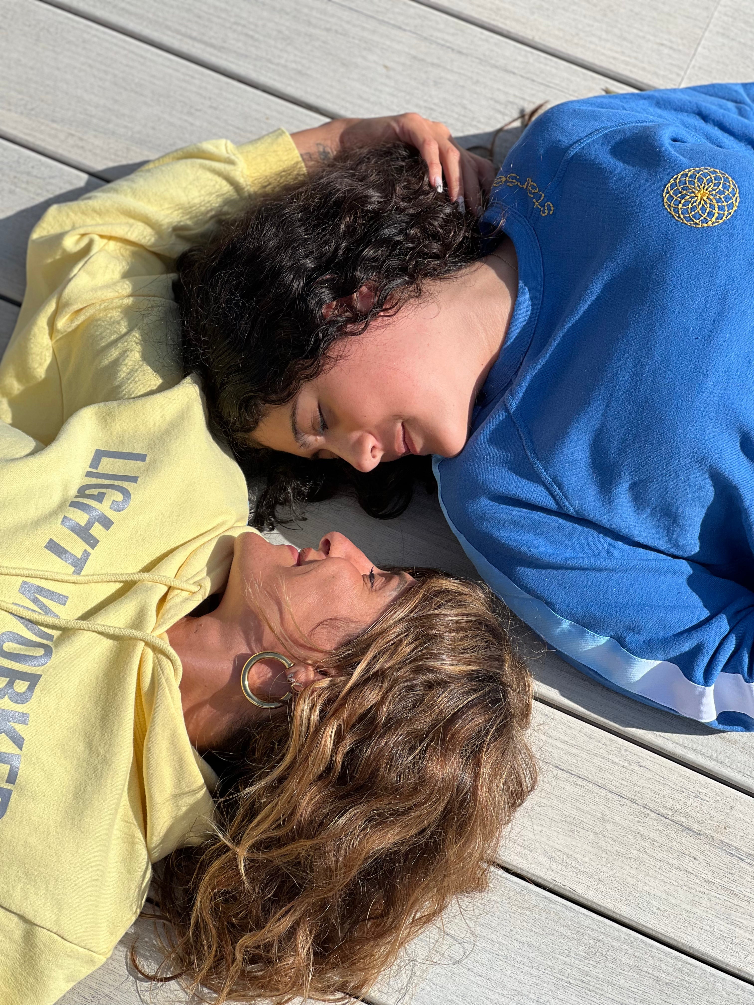 mother and daughter resting together in contrasting sets