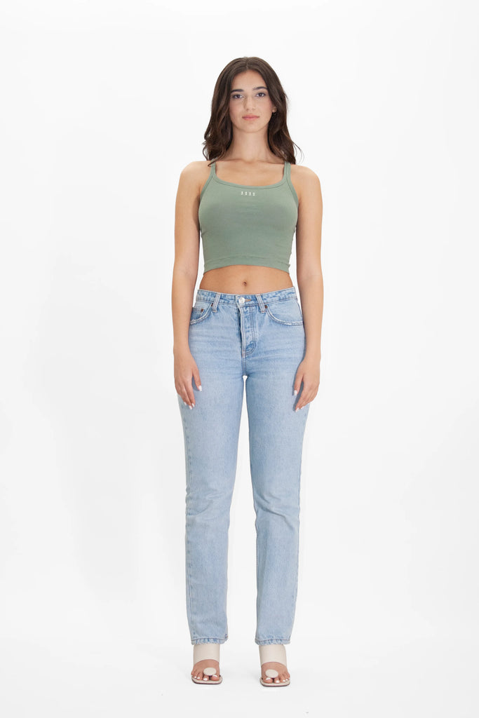 The model is wearing a Angel Number 1111 Cropped Tank in Sage by GFLApparel and jeans.