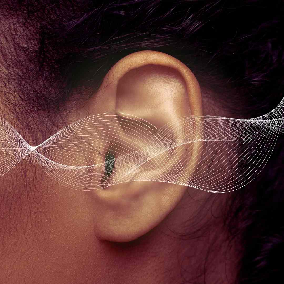 an ear with a visual of sound waves