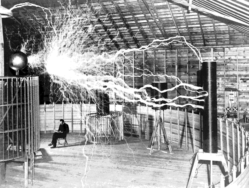 Nikola Tesla 369 - Tesla sits in his lab with huge bolts of electricity over