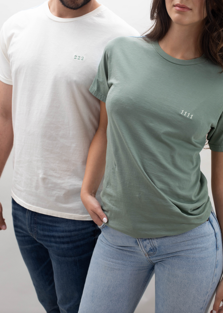 A man and woman standing next to each other wearing t - shirts.