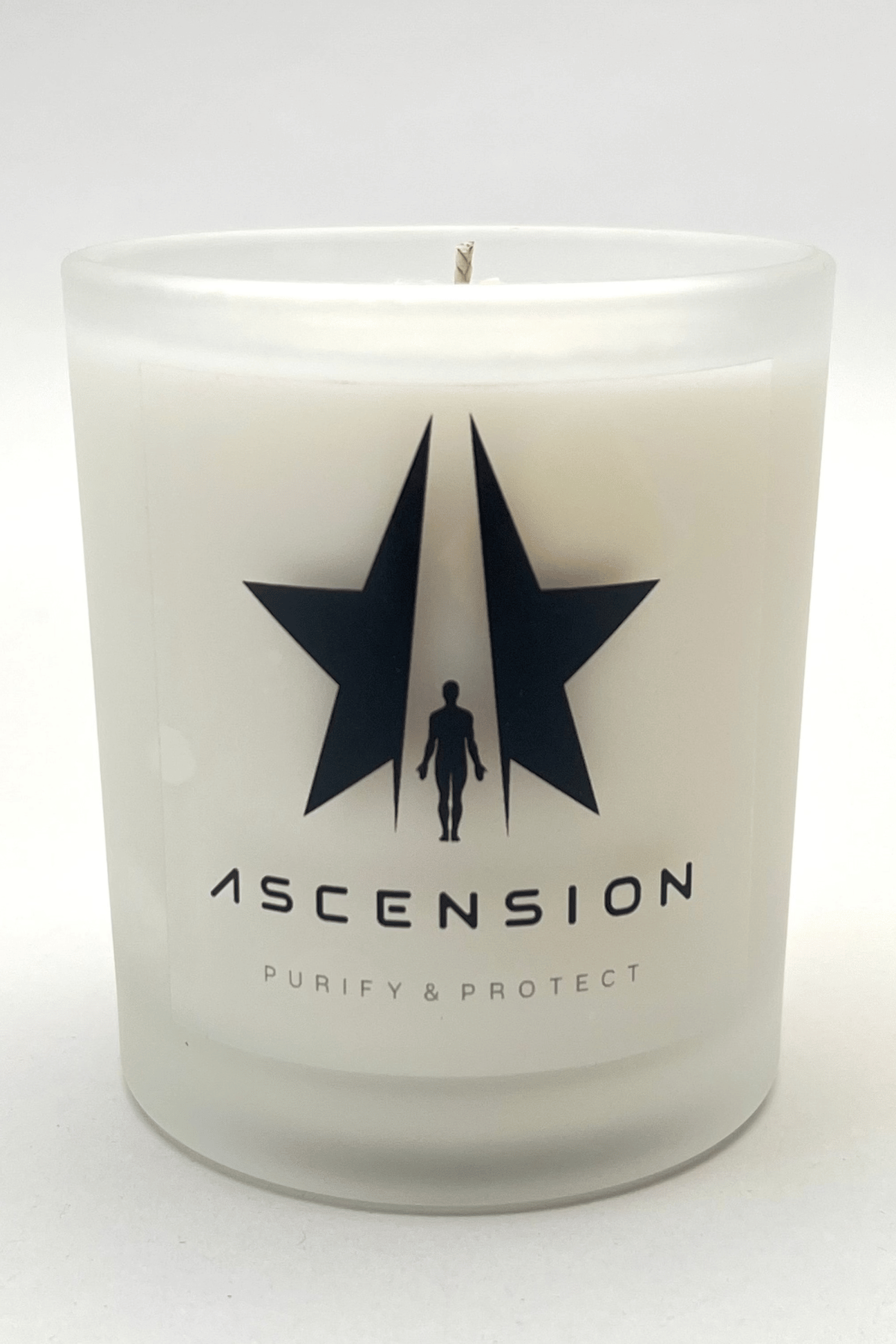 A frosted glass candle jar with black star and silhouette logo, and the text "ASCENSION" and "PURIFY & PROTECT" printed on it. The Ascension Candle by Galactic Federation of Light features non-carcinogenic soy wax blended with essential oils, making it both luxurious and safe for your home.