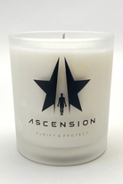 A frosted glass candle jar with black star and silhouette logo, and the text "ASCENSION" and "PURIFY & PROTECT" printed on it. The Ascension Candle by Galactic Federation of Light features non-carcinogenic soy wax blended with essential oils, making it both luxurious and safe for your home.