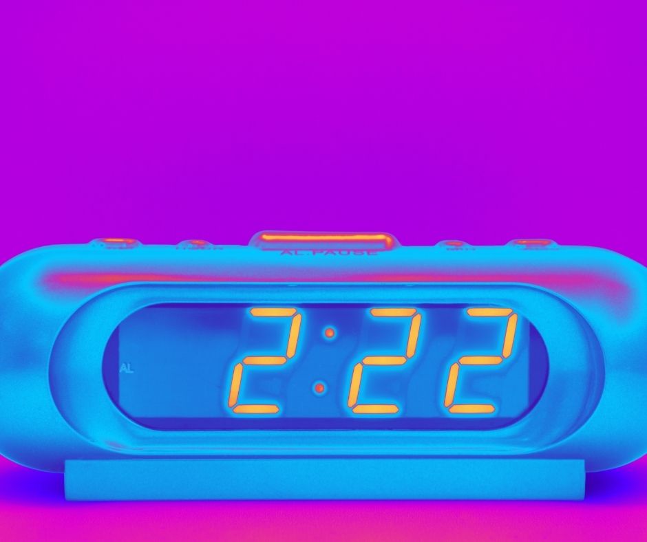 222 on an alarm clock with a pink background
