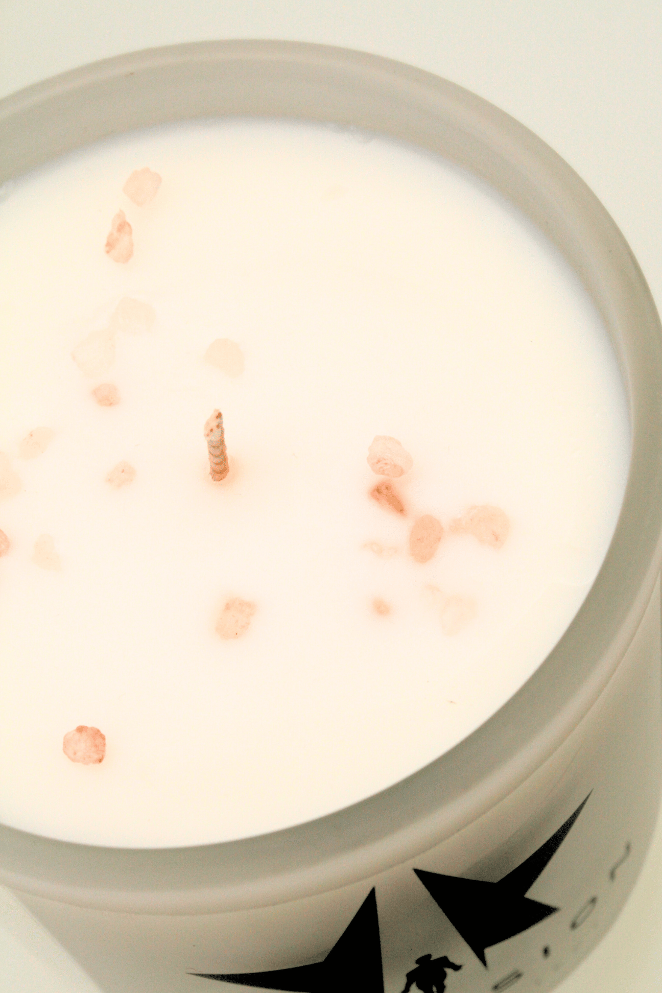 The Galactic Federation of Light Ascension Candle features a white candle made from non-carcinogenic soy wax with a single wick and scattered pink salt crystals on top, all housed in a frosted glass container.