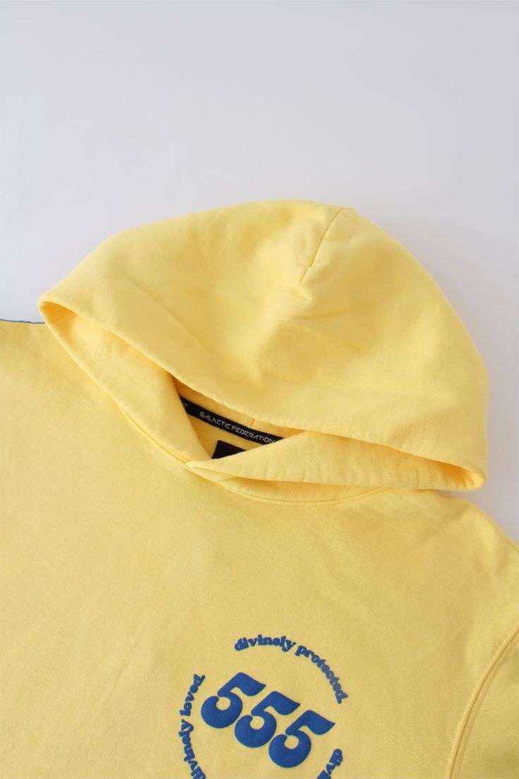 Yellow hoodie with blue text 555 on a white background