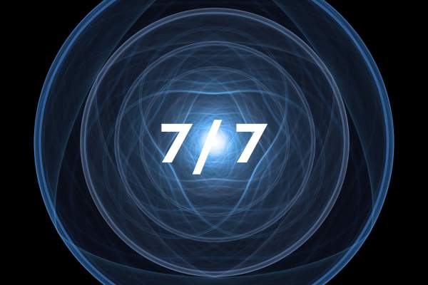 Circular blue light effect with '7/7' text in the center on a black background