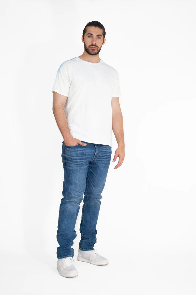 A man wearing an Angel Number 222 Tee in Bone by GFLApparel and jeans.