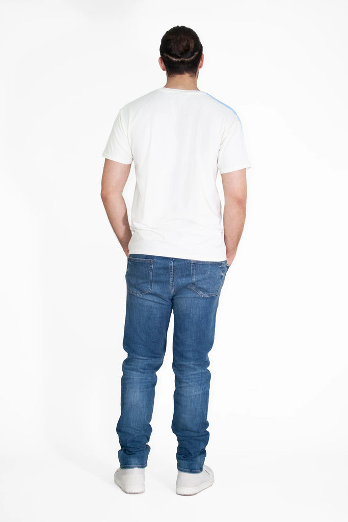 The back view of a man wearing GFLApparel's Angel Number 222 Tee in Bone and jeans.