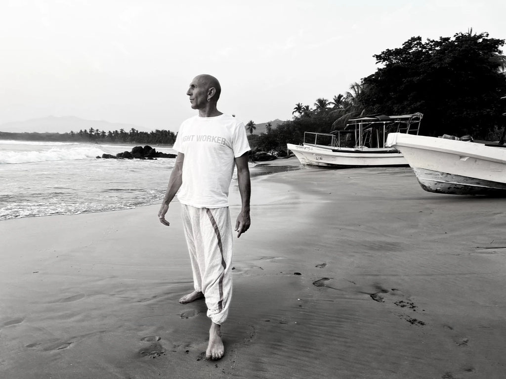 Dotan Shoham looks to the horizon while walking barefoot on the beach