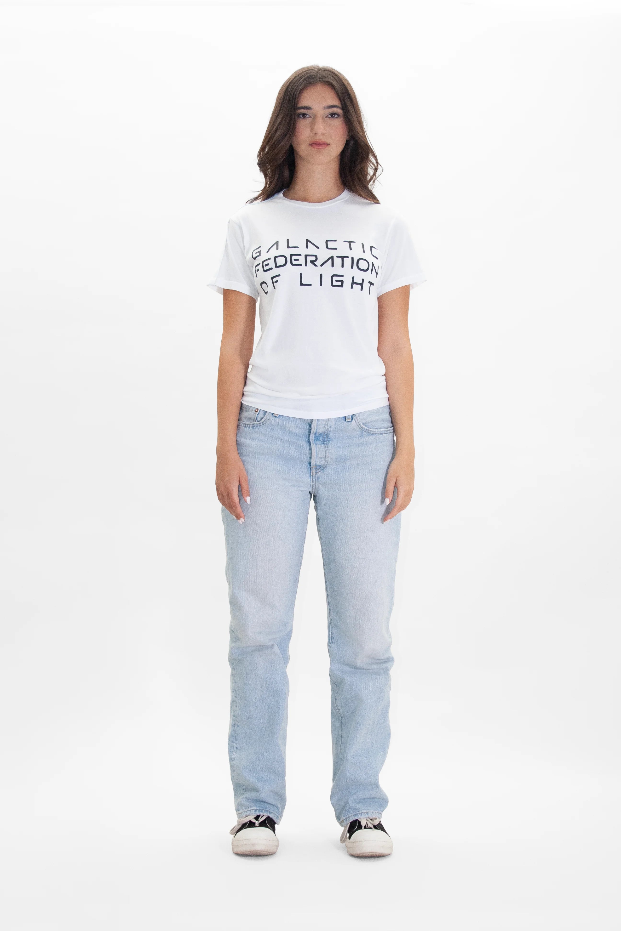 A woman wearing a GFL STACK TEE IN LITE BEAM t-shirt and jeans from the brand GFLApparel.