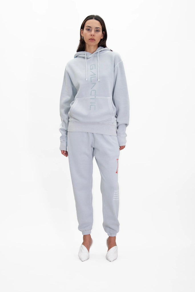 A woman wearing a HYPERGALACTIC HOODIE IN GALACTIC GRAY by GFLApparel and joggers.