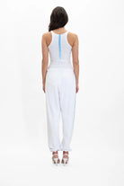 The back view of a woman wearing the GFL Tank Top in Lite Beam by GFLApparel.