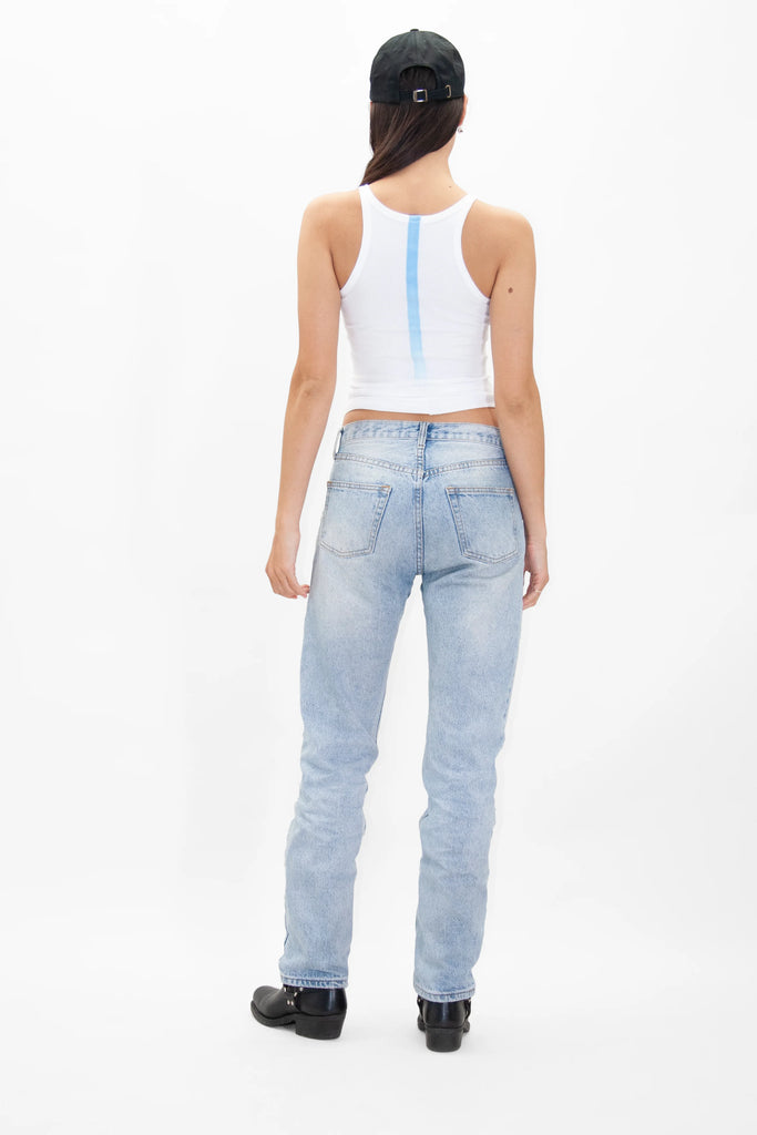 The back view of a woman wearing jeans and a GFLApparel LIGHT WORKER BASEBALL CAP.