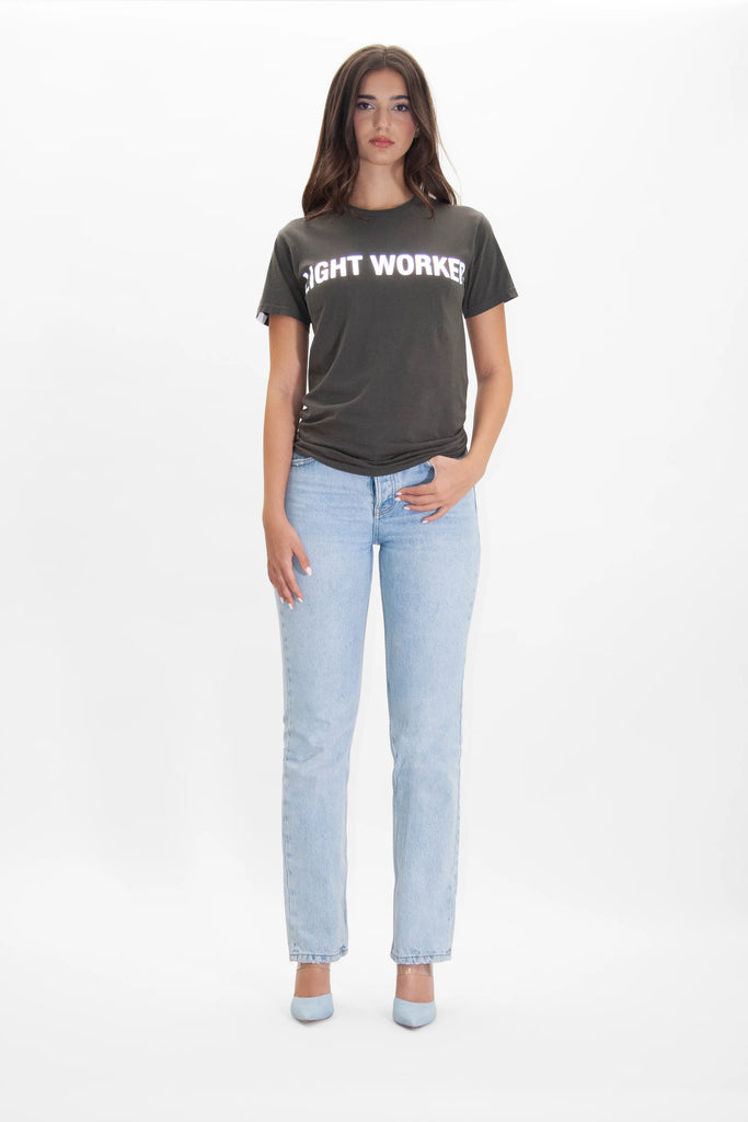 A woman wearing a LIGHT WORKER TEE IN CALADAN by GFLApparel and jeans.
