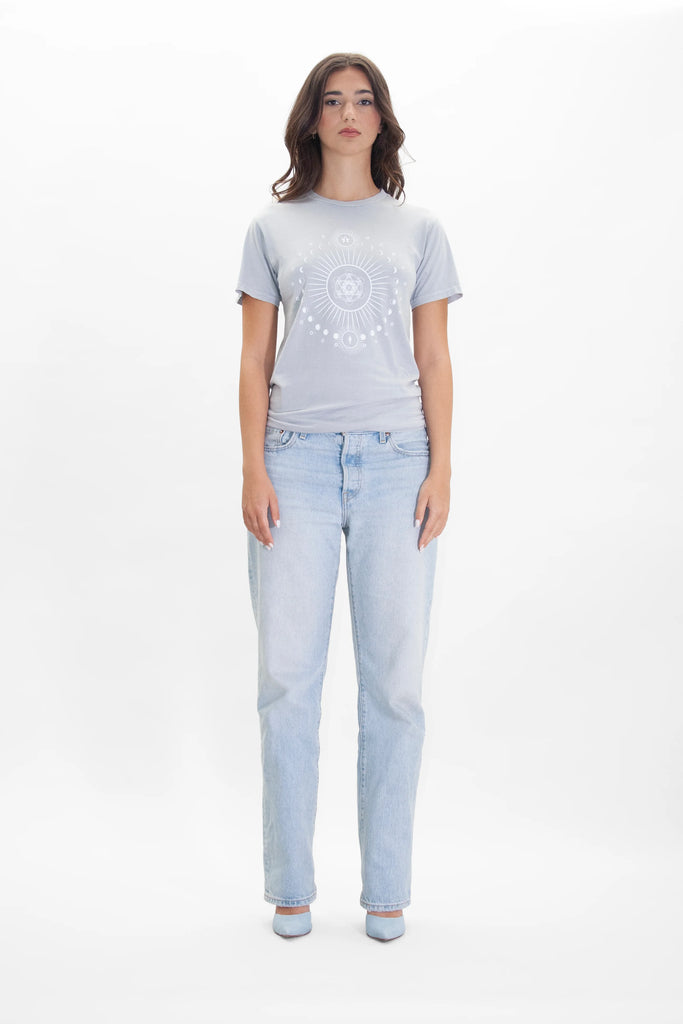 A woman wearing a MOON METATRON TEE IN GALACTIC GRAY by GFLApparel and jeans.