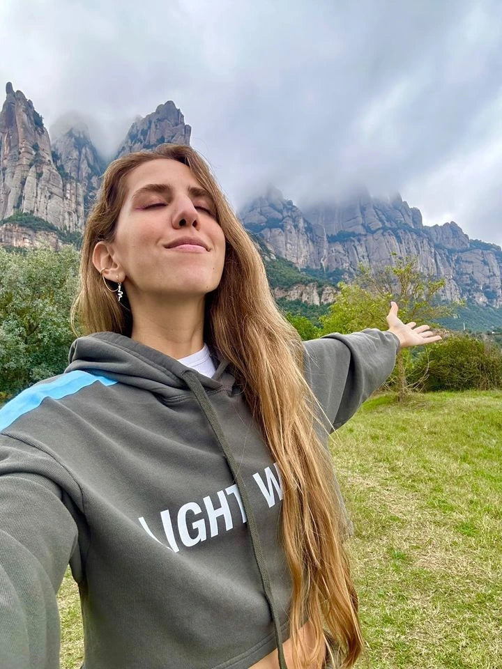 Mercedes Arraut takes a deep breath of mountain air in a GFL cropped hoodie