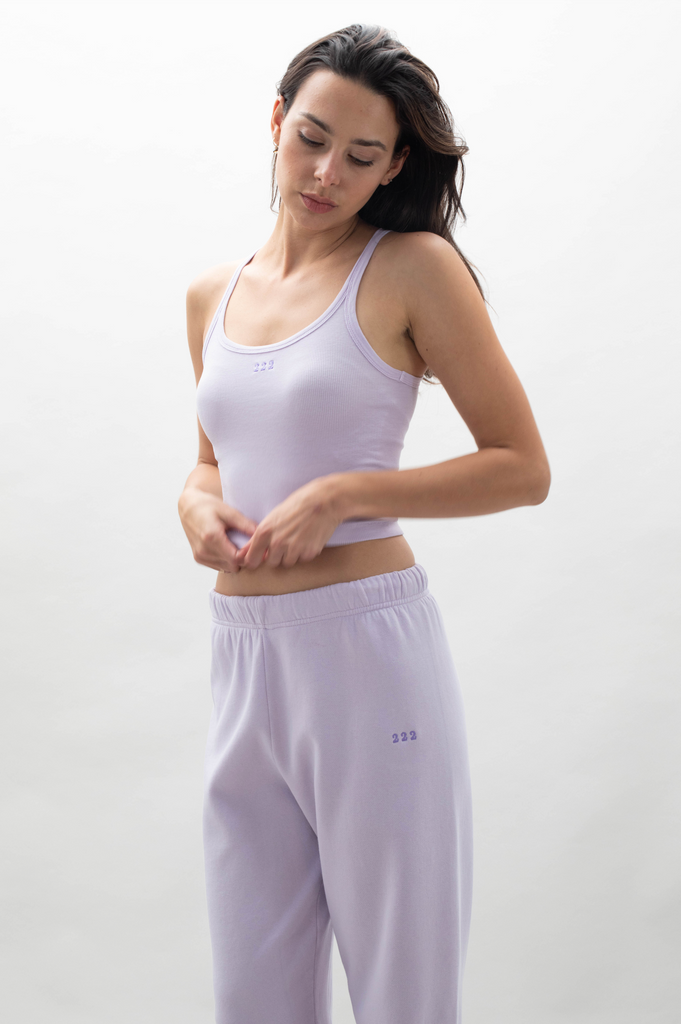 A woman wearing Angel Number 222 pants and joggers from GFLApparel.