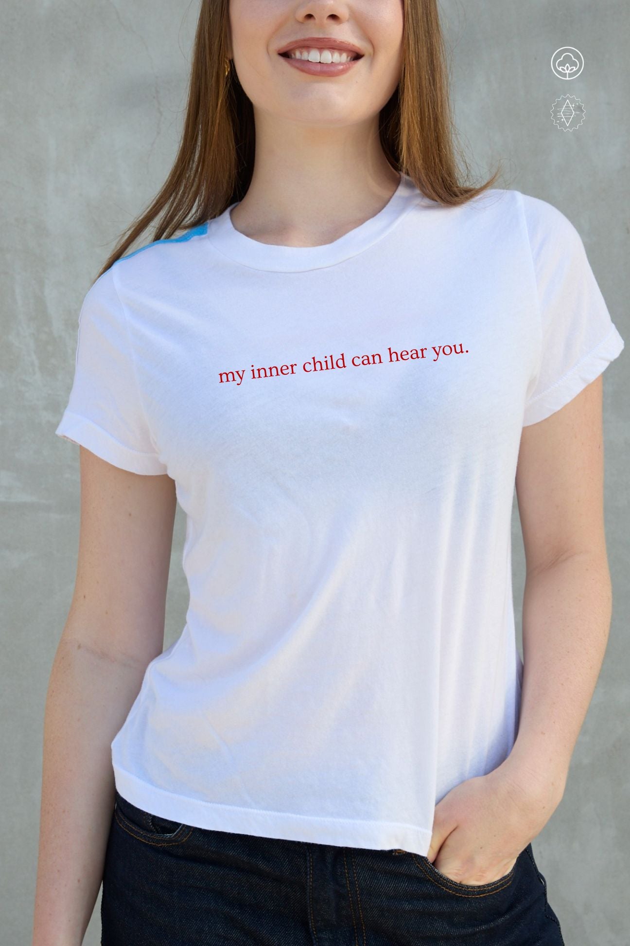 Person wearing a white t-shirt with red text against a gray background