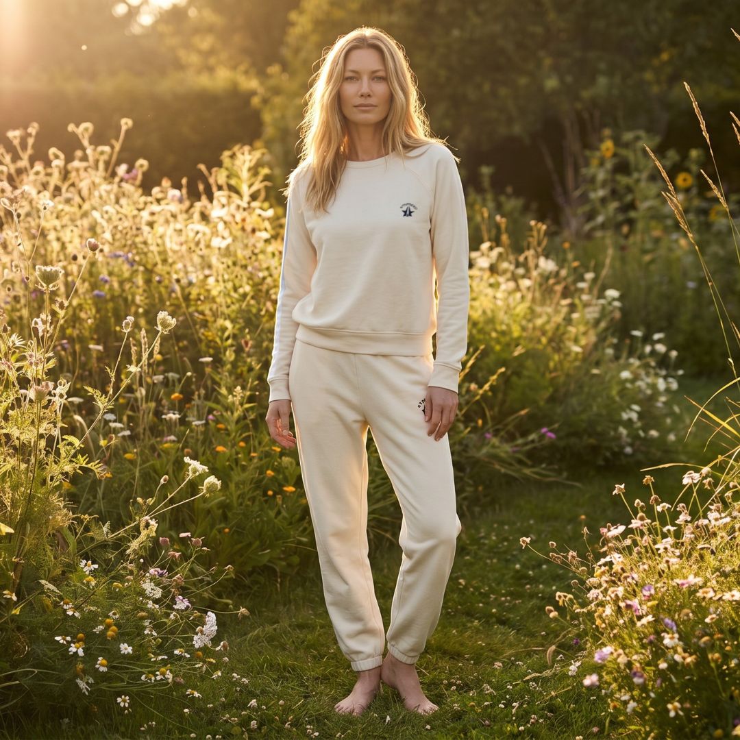 woman standing in a flowery field wearing a cream set 