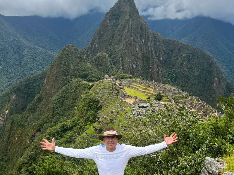 a man in a Light Worker shirt in Macchu Pichu