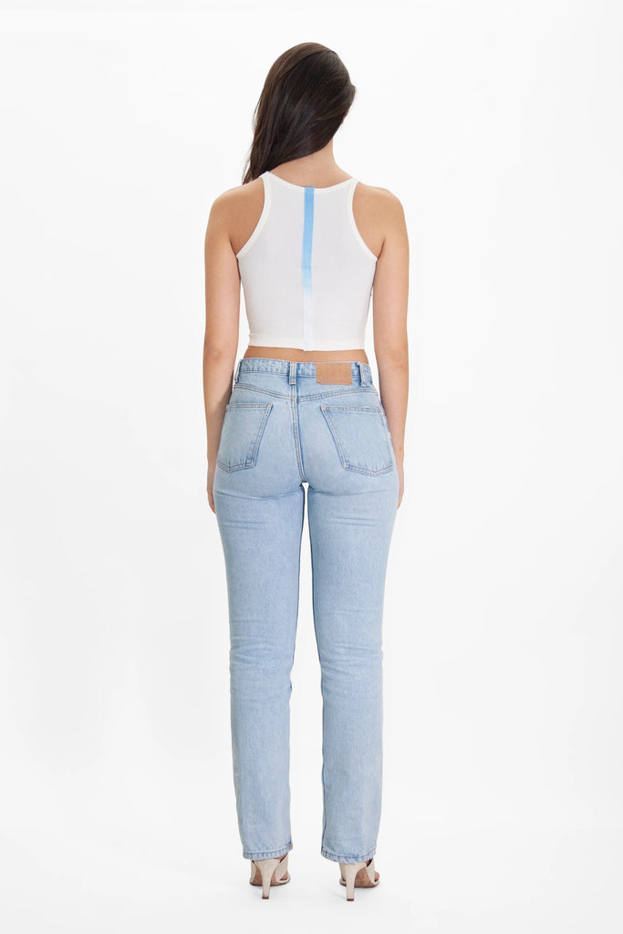 The back view of a woman wearing Angel Number 1111 Cropped Tank in Bone by GFLApparel light blue jeans and a white crop top.