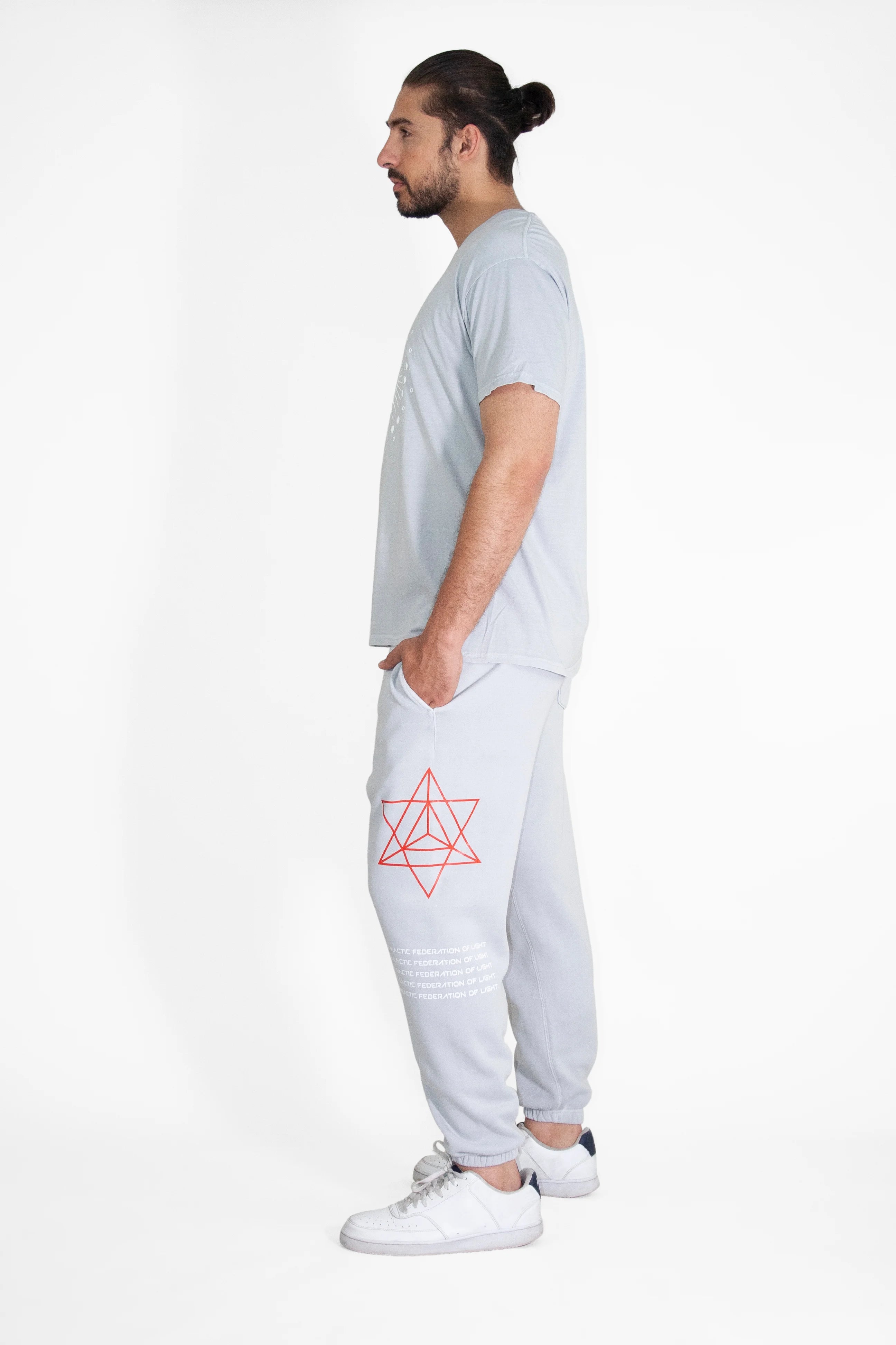 A man wearing HYPERGALACTIC PANTS IN GALACTIC GRAY from GFLApparel and a red t-shirt.