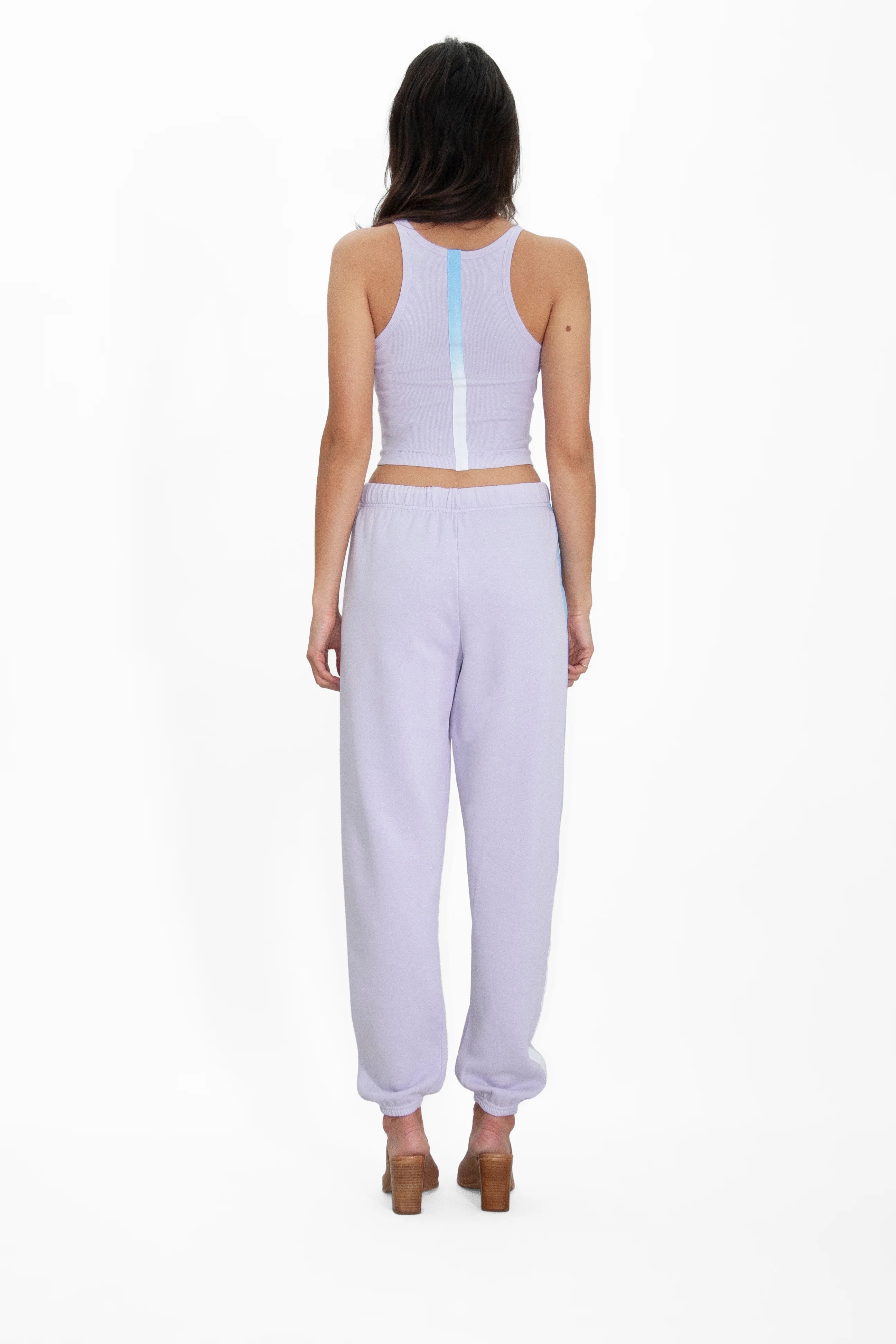 The back view of a woman wearing GFLApparel's Angel Number 222 Pants and joggers.
