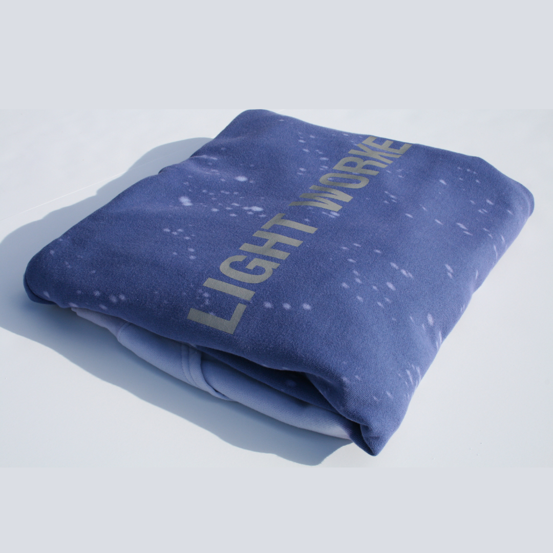 A folded, dark blue blanket with white specks and the words 
