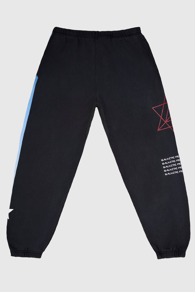 Hypergalactic Pants in Space Glow from GFLApparel made from a heavyweight cotton blend, featuring an elastic drawstring waistband and cuffs. The right leg showcases a red geometric star pattern with white text, and the left leg includes a striking blue stripe detail.