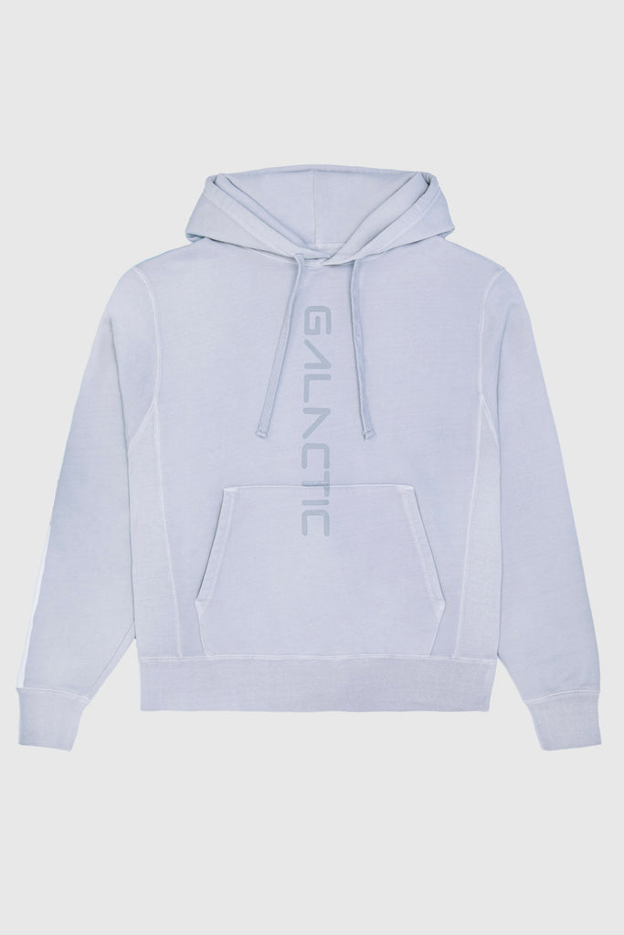 Light gray GFLApparel Hypergalactic Hoodie in Galactic Gray made from a heavyweight cotton blend, featuring a front pocket and the word "GALACTIC" printed vertically down the center. Handcrafted in LA for ultimate comfort and style.